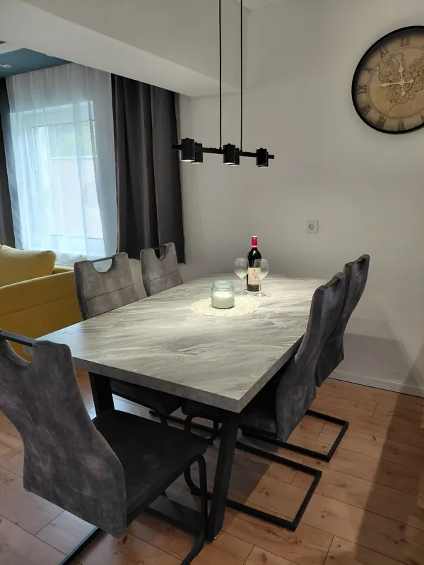 Dining table with a candle and a bottle of wine