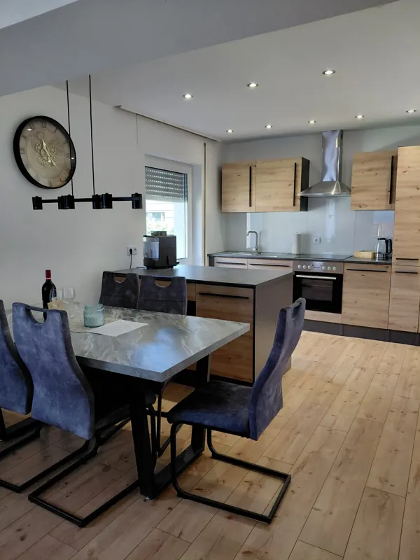 Kitchen with wooden cabinets, oven and coffee machine