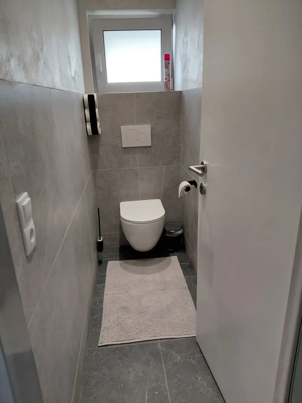Separate WC with grey tiles